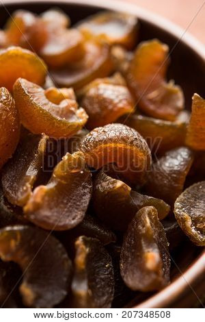 Ayurvedic Amla Candy, which is dried and salty-sweet or chatpata in taste and digestive. Served in a wooden bowl, selective focus