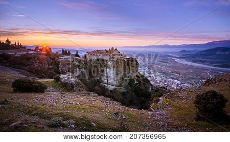 Breathtaking view of Meteora at sunset, Greece. Geological formations of big rocks with Monasteries  on top of them.