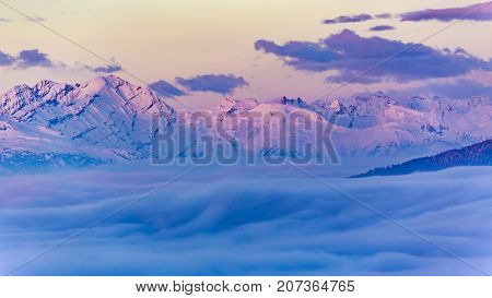 Scenic panorama sunset landscape of Crans-Montana range in Swiss Alps mountains with peak in background, Crans Montana, Switzerland.