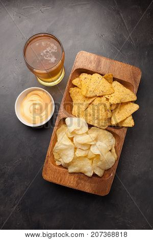 Beer In Glasses Closeup On The Concrete Table. Beer And Snacks Are Chips And Nachos With Cheese Souc