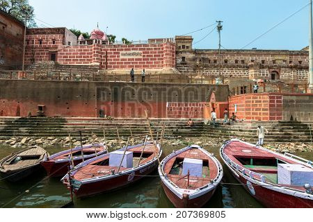 VARANASI INDIA - MARCH 14 2016: Horizontal picture of many boats at Ganges River in front of Chet Singh Ghat in the city of Varanasi in India