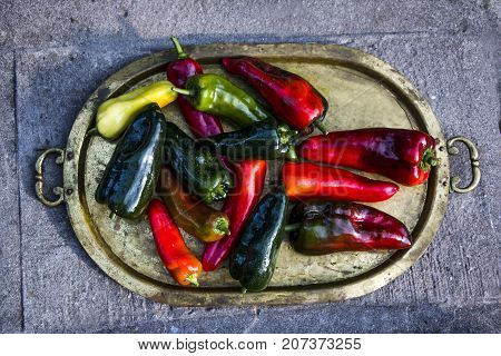 Fresh  picked peppers on a brass tray