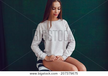 Sexy girl in a gray sweatshirt and panties. Mock-up.