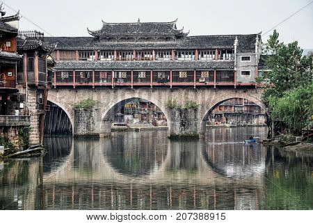 Fenghuang, the most beautiful ancient town in China and its bridge-house under the Tuo river.