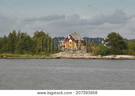 Traditional wooden house on a finnish lake. Finland landscape. Colorful