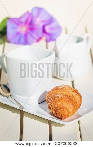 Delicious croissants with cup of coffee for breackfast on white table