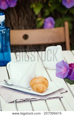 Delicious croissants with cup of coffee for breackfast on white table