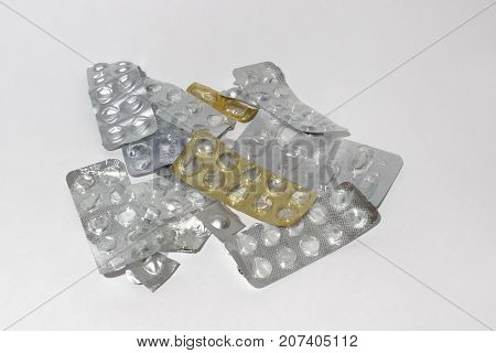 heap of old empty blister packs of pills