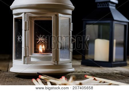 Two Small Lanterns On A Wooden Table. Candle In Old Latarence. Wooden Table.