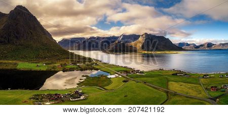 Aerial view of a scenic road along the coastline and  high mountains on Lofoten islands in Norway