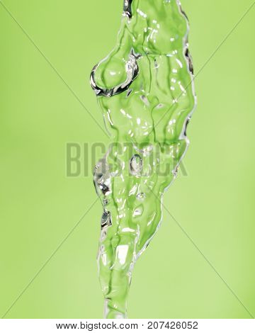 a jet of water on a green background