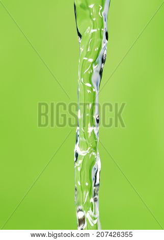 a jet of water on a green background