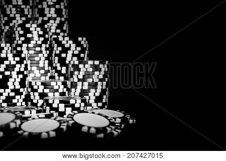 Stack of Poker chips on a green gaming poker table at the casino. Poker game concept. Playing a game with dice. Casino Concept for business risk chance good luck. chips for poker game. Black and white