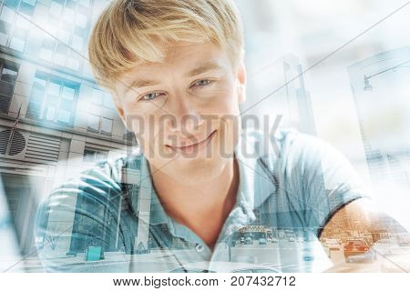 Undeniably handsome. Close up of positive good looking light haired man with charming smile and sincere love in his eyes