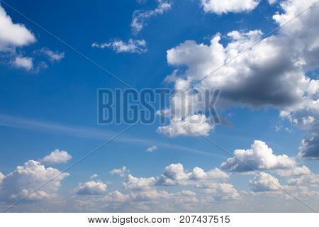 White light clouds in the blue sky on a summer sunny day.