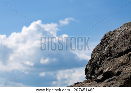 Clouds in the background with rocks rocks in the foreground.