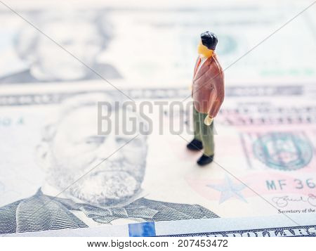 close up miniature man on dolla banknote