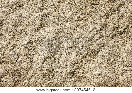 The granite surface of the wall is light brown in color.
