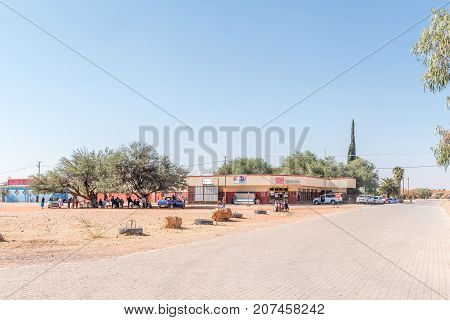 GOCHAS NAMIBIA - JULY 5 2017: A street scene with a supermarket vehicles and people in Gochas in the Hardap Region in Namibia