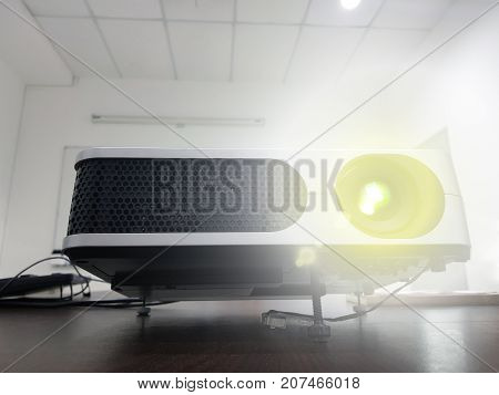 LED projector on wood table in a room projector home theater concept.