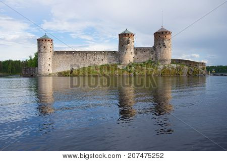 Olavinlinna fortress in the cloudy June evening. Savonlinna, Finland