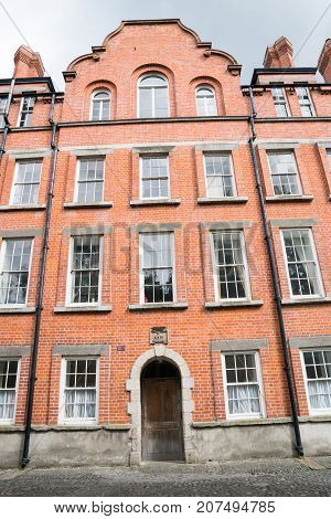 DUBLIN IRELAND - AUGUST 9 2017; Red brick four storey architecture of houses at Trinity College in Dublin in Irish Republic.