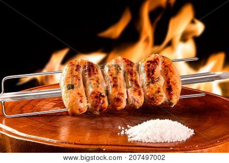 Linguica cuiabana traditional Brazilian barbecue. fire background