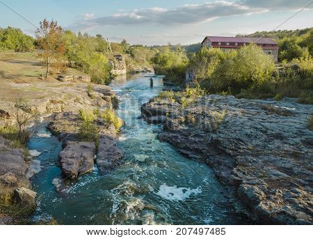 day in the afternoon flowing river Gorny Tikich among stones and a canyon in the village of Buki Ukraine