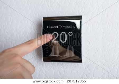Finger Touching Digital Thermostat Temperature Controller At Home