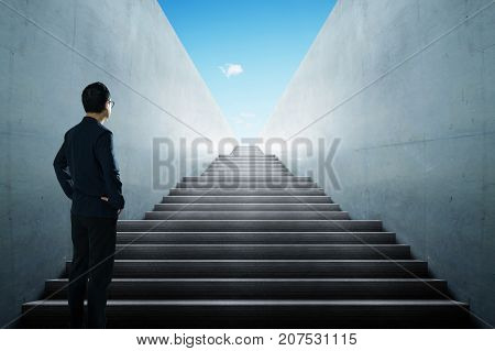 Businessman looking and thinking front of a stair infinty view .