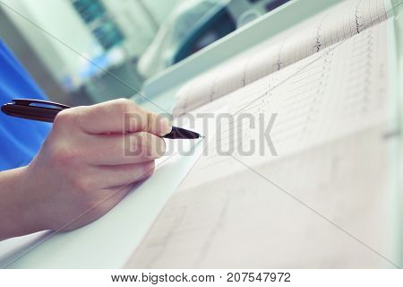 Doctor examinaes patient's results and other data.