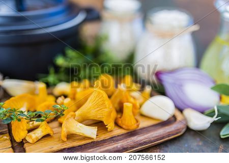 Ingredients for preparing risotto, Italian food. Fresh chanterelle mushrooms with arborio and herbs.