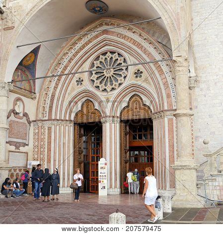 ASSISI ITALY 30 JUNE 2017: Famous Basilica of St. Francis of Assisi (Basilica Papale di San Francesco) with Lower Plaza at sunset in Assisi Umbria Italy