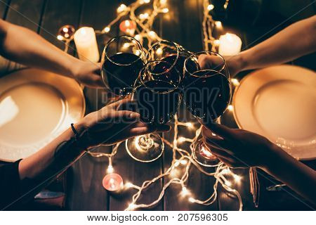 Four People Clinking Glasses With Wine