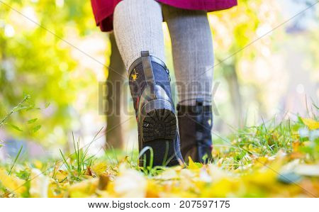 A Girl In Black Boots Trampled On Leaves, Autumn, Yellow Leaves On The Floor, Woman's Legs