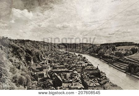 Embankment of the River Meuse in the Belgian City of Dinant. Beautiful small town Dinant in Belgium. Vintage style toned picture