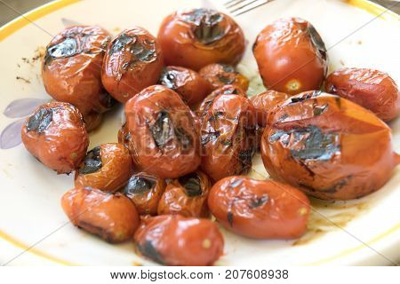 cherry tomatoes roasted on the griddle on barbecue