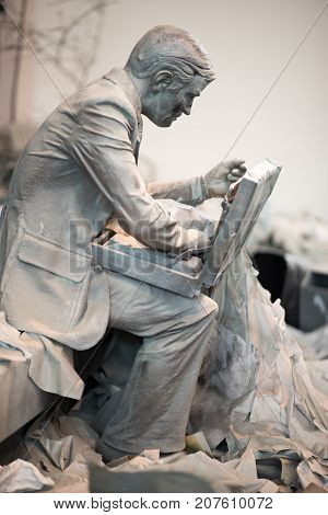 TRENTON, NJ - JUNE 17, 2017: View of Business man sitting down with breifcase at the Grounds for Sculpture