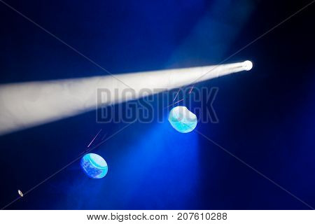Rays theatrical spotlights on the stage during the performance. Lighting equipment. The lighting designer. Theatrical smoke. The art and creativity.