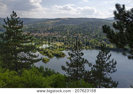 Scene with mountain, lake, glade, forest and residential district of bulgarian village Pancharevo, Sofia, Bulgaria