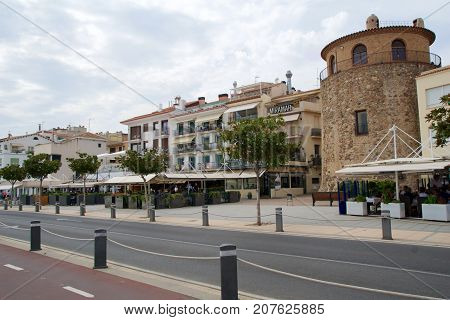 CAMBRILS, SPAIN - AUG 27th, 2017: Museu d'Hist'ria de Cambrils - Torre del Port. Seafront with restaurants and pubs.