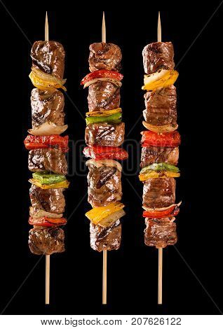 Meat Skewer With Vegetables On A Black Background. Paulistinha.