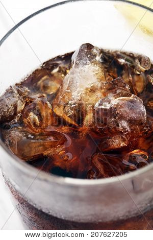 Softdrink With Ice Cubes, Lemon And Straw In Glass