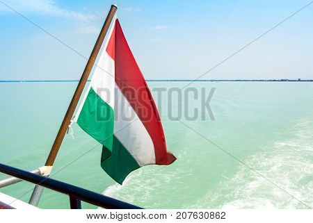 Hungarian Flag At The Cruise Ship With Bright Light Blue Water Of Balaton Lake At The Background Hun