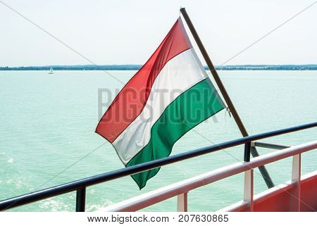 Hungarian Flag At The Cruise Ship With Bright Light Blue Water Of Balaton Lake At The Background Hun