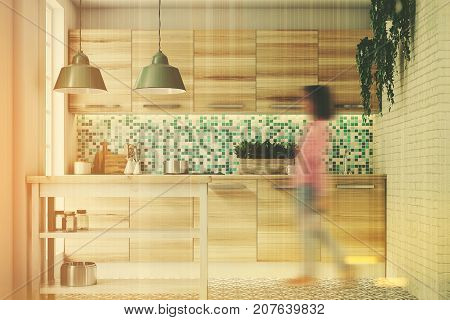 Woman in an upscale kitchen interior with green and white mosaic walls large windows an interesting floor pattern and wooden consoles and a table. 3d rendering toned image double exposure