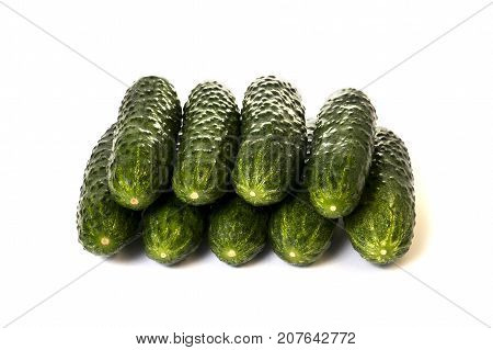 Nine vegetables green cucumbers on a white background