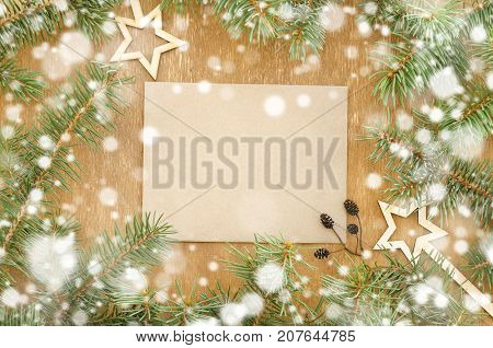 Christmas tree frame and envelope with decoration on wooden background. Copy space composition. Copy space background top view flat lay overhead