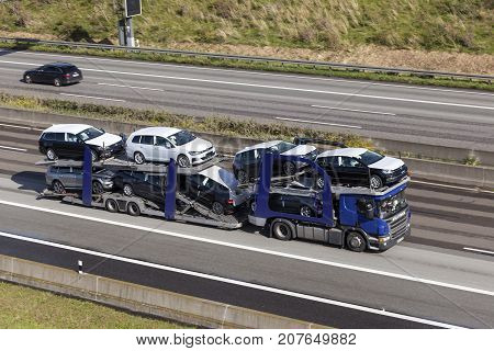 Frankfurt Germany - Sep 19 2017: Scania P410 car transporter hauls new Volkswagen Golf cars along the A45 highway in Germany