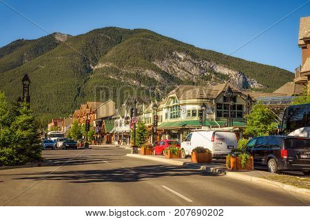 BANFF, ALBERTA, CANADA - JUNE 27, 2017 : Scenic street view of the Banff main shopping street in a sunny summer day. Banff is a resort town and popular tourist destination.